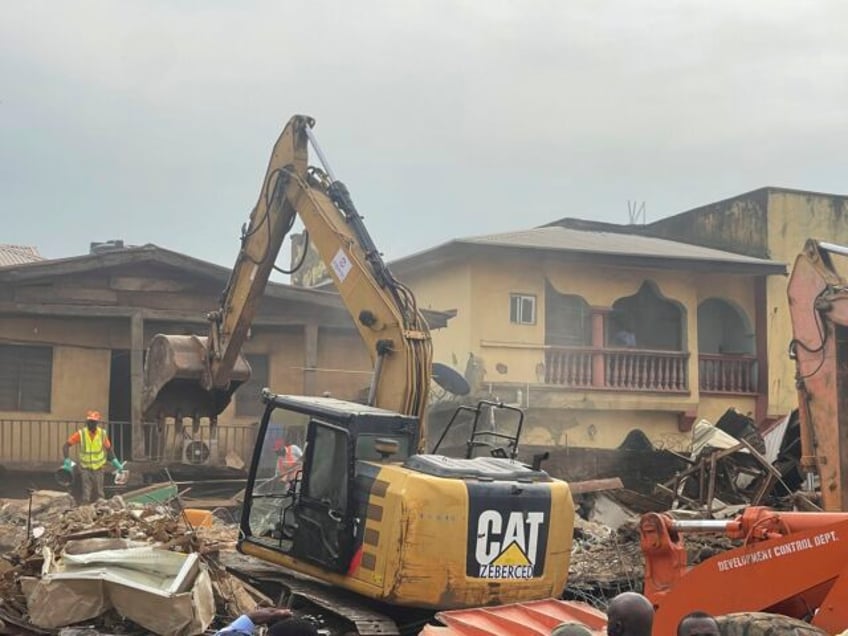 building collapse in nigerias capital leaves two people dead while many are feared trapped