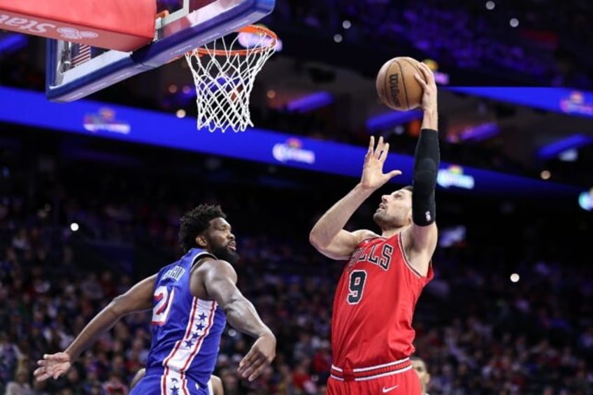 Chicago's Nikola Vucevic shoots a lay up over Philadelphia 76ers star Joel Embiid in the Bulls' 108-104 victory over the Sixers