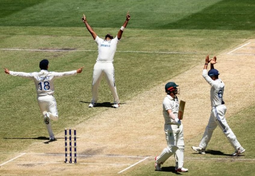 India's Jasprit Bumrah (second left) and Virat Kohli (left) celebrate the wicket of Austra