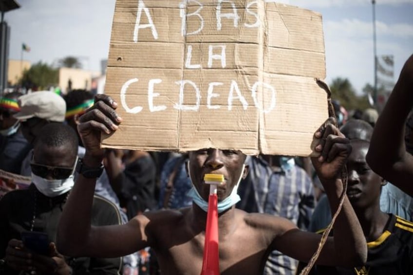 'Down with ECOWAS' says a placard at a January 2022 protest in Bamako against sanctions imposed on Mali by the West African bloc