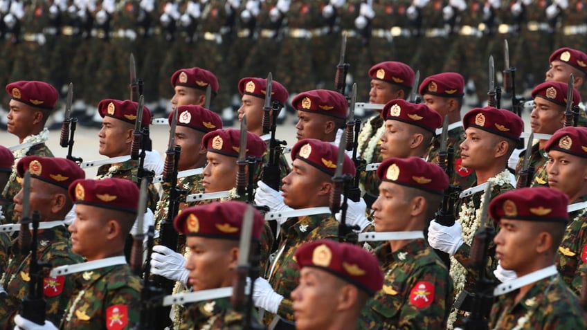 Burmese military officers march during a parade