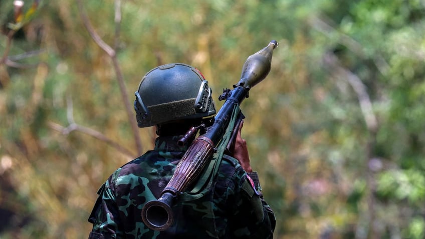 A soldier from the Karen National Liberation Army (KNLA) carries an RPG launcher