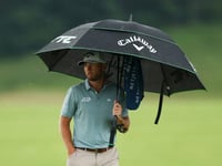 Burns leads Scott by one as dangerous weather halts US Open