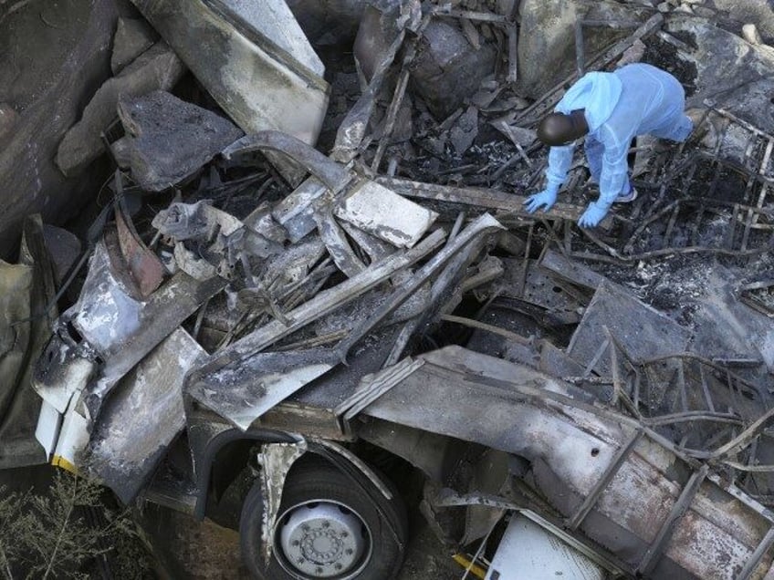 The wreckage off a bus lies in a ravine a day after it plunged off a bridge on the Mmamatl