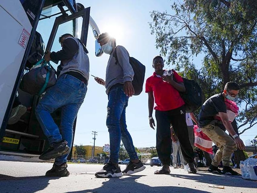 Migrants board a bus to the airport Friday, Oct. 6, 2023, in San Diego. San Diego's well-oiled system of migrant shelters is being tested like never before as U.S. Customs and Border Protection releases migrants to the streets of California's second-largest city because shelters are full. (AP Photo/Gregory Bull)