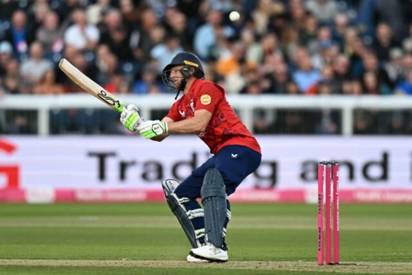 England's Jos Buttler scoops a ball from West Indies' Alzarri Joseph on his way to 96 in t