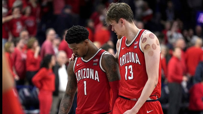 Caleb Love and Henry Veesaar walk off the floor