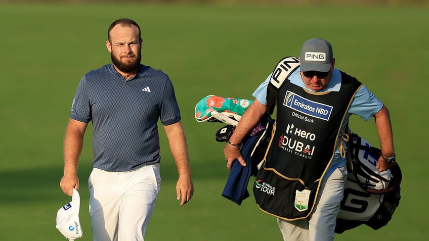 Tyrrell Hatton with his caddie