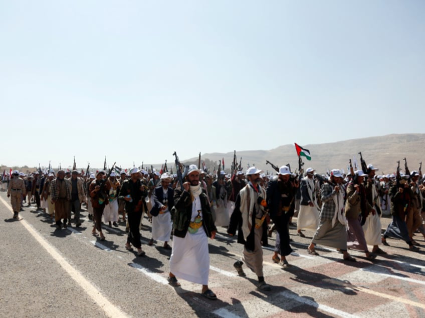 Amran, YEMEN - DECEMBER 20: Yemen's Houthi loyalists take part in an armed parade for more than 20,000 members who have finished a military course, staged to show their willingness to battle any potential attack by the recently created coalition by the U.S., on December 20, 2023 in Amran province, Yemen. Yemen's Houthi movement leader has warned that they would attack US ships in the Middle East if Washington waged war against them. (Photo by Mohammed Hamoud/Getty Images)