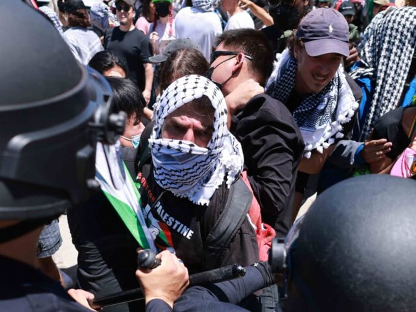 Los Angeles Police Department (LAPD) officers clash with anti-Israel protesters wearing Pa