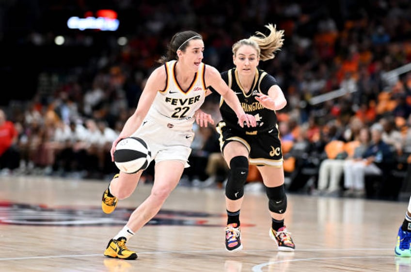 Caitlin Clark of the Indiana Fever handles the ball in the first quarter against Karlie Samuelson of the Washington Mystics at Capital One Arena on...