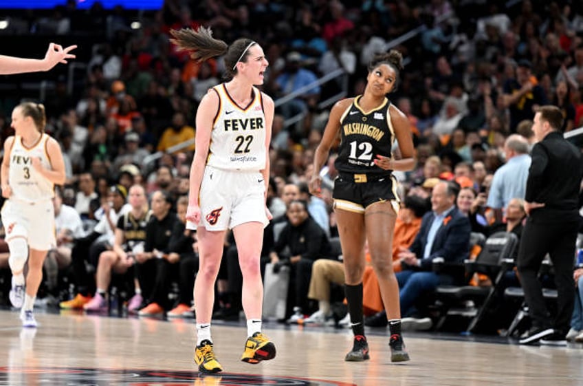 Caitlin Clark of the Indiana Fever celebrates after scoring in the third quarter against the Washington Mystics at Capital One Arena on June 07, 2024...