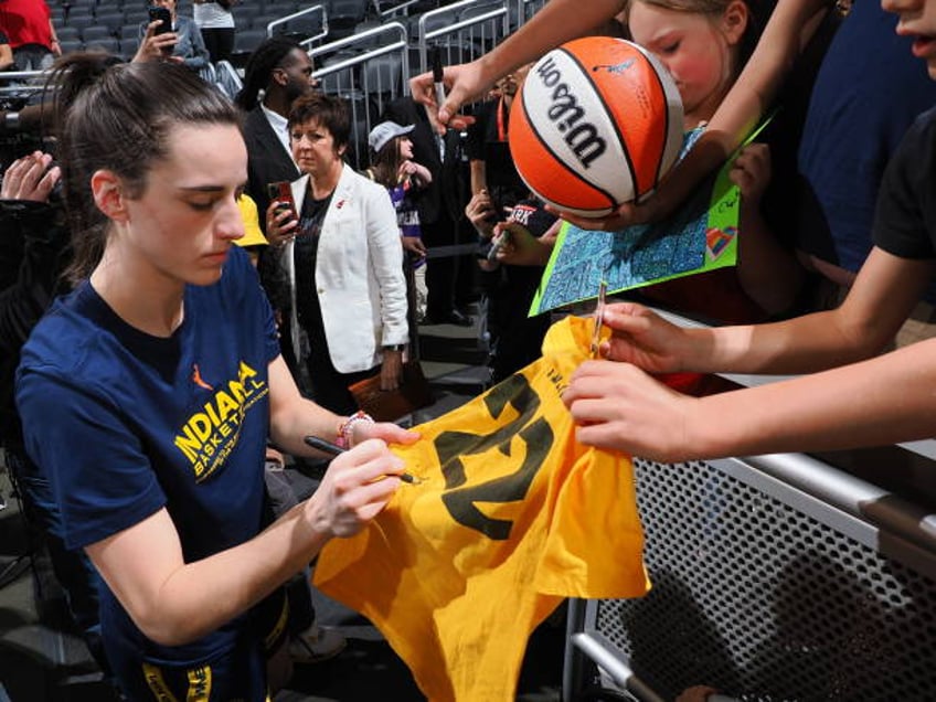 Caitlin Clark of the Indiana Fever signs autographs for fans before the game against the Chicago Sky on June 1, 2024 at Gainbridge Fieldhouse in...