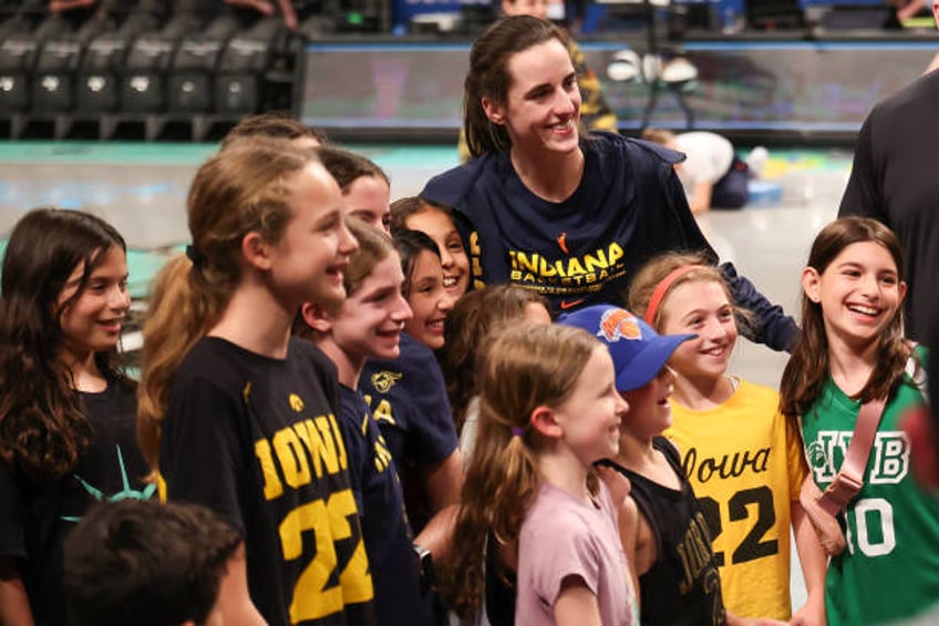 Caitlin Clark of the Indiana Fever poses for a photo with fans before a game against the New York Liberty at Barclays Center on June 02, 2024 in New...