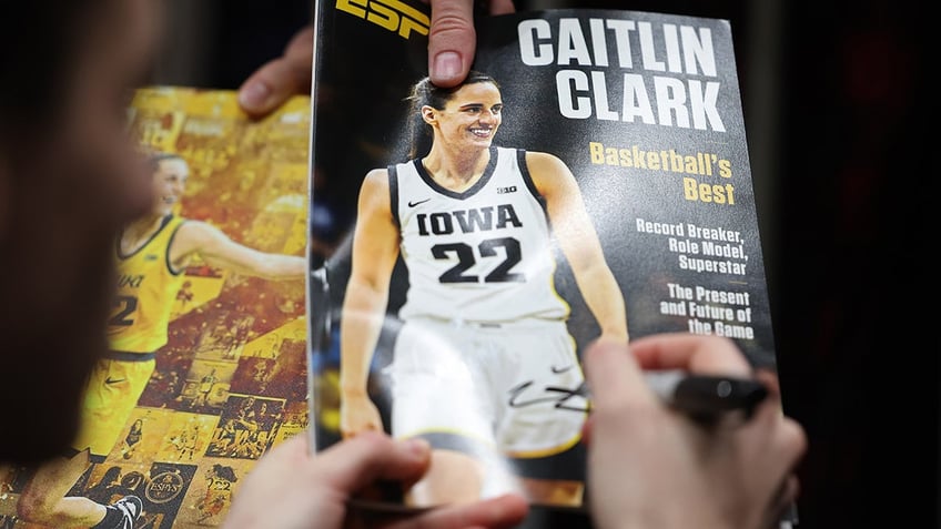 Caitlin Clark signs autograph