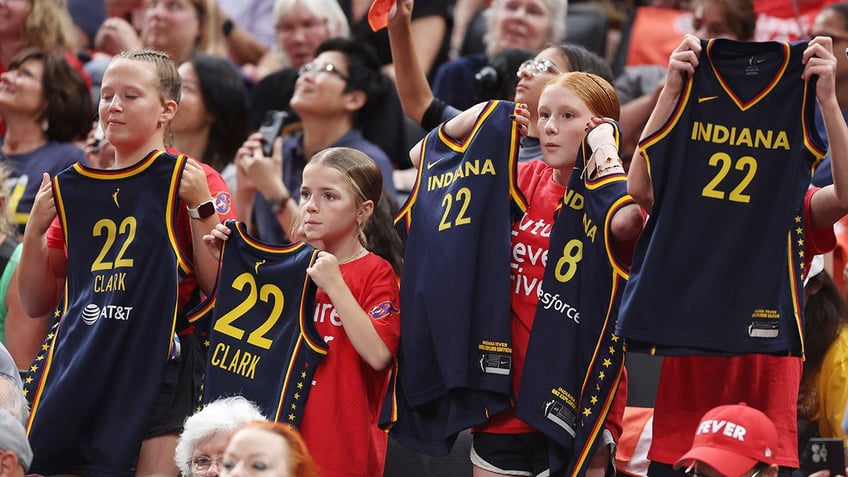Fever fans hold up jerseys