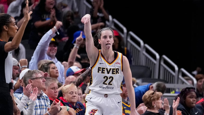 Caitlin Clark reacts after making a basket