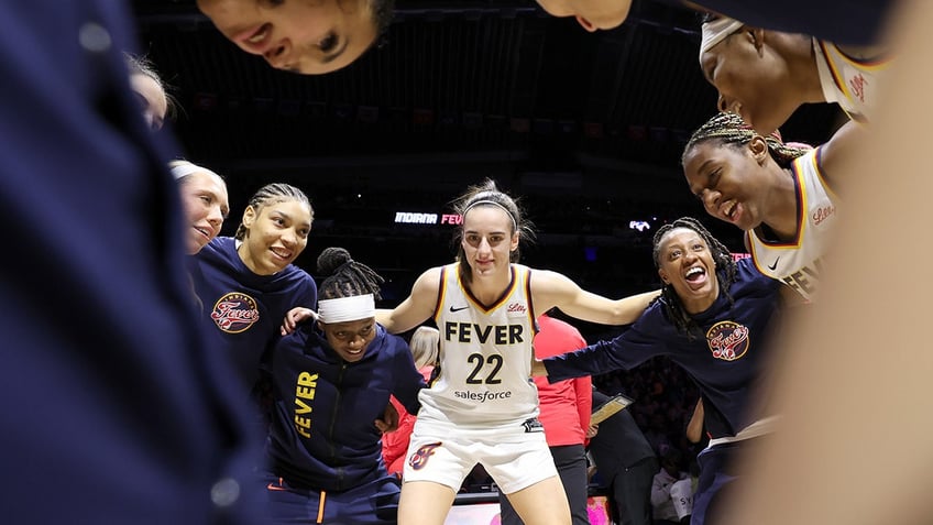 Caitlin Clark huddles with teammates