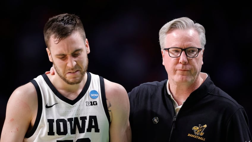 Head coach Fran McCaffery hugs his son Connor McCaffery 