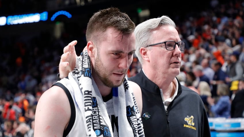 Head coach Fran McCaffery hugs Connor McCaffery 