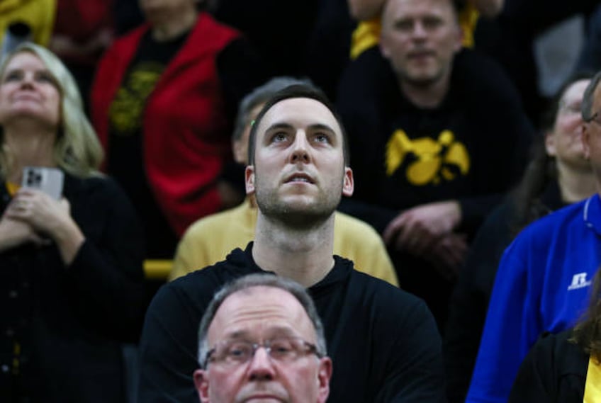 Former Iowa player Connor McCaffery watches on during the record breaking performance by guard Caitlin Clark of the Iowa Hawkeyes in the match-up...