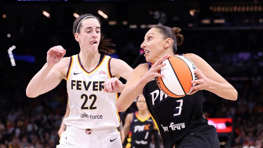 Diana Taurasi drives on Caitlin Clark