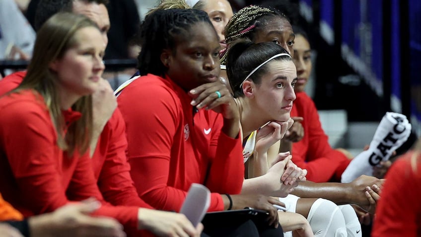 Caitlin Clark sits on the bench