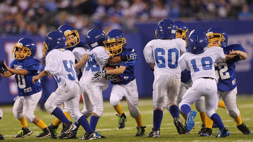 Kids running in blue jerseys