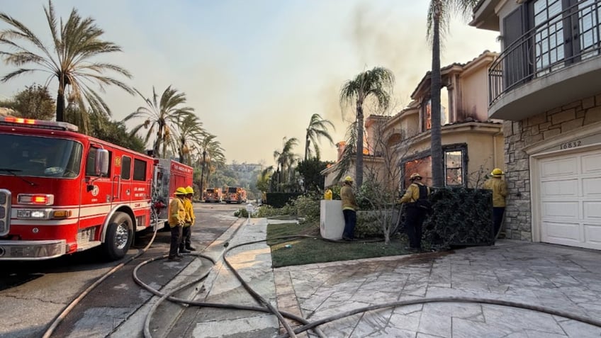 Firemen put out a fire on Mallen's street