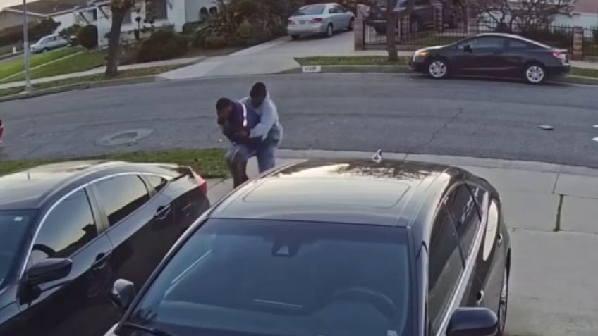 man fighting mail carrier