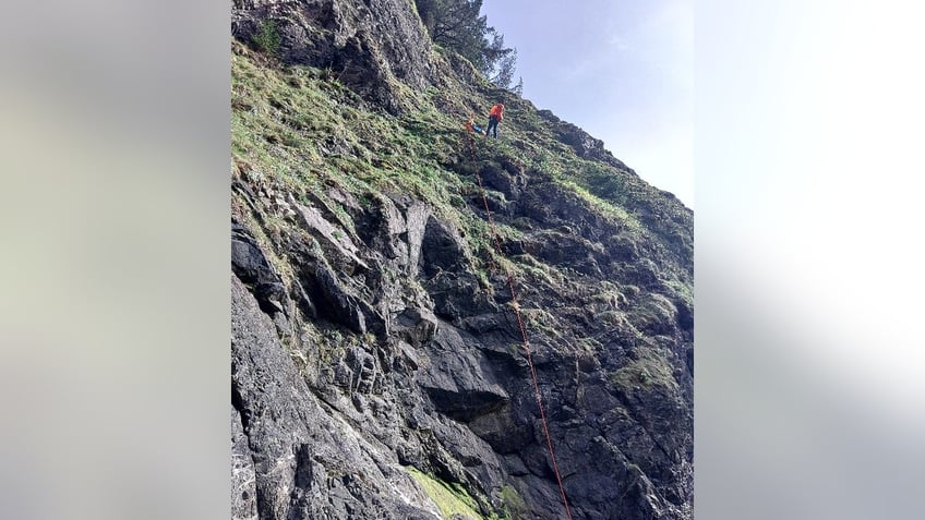 search and rescuer on steep and rocky slope