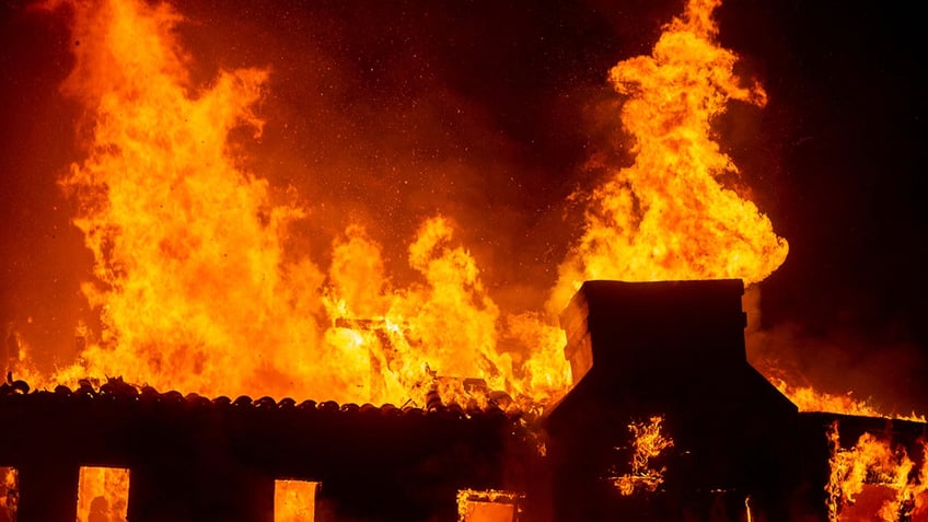 Palisades fire burns during a windstorm on the west side of Los Angeles