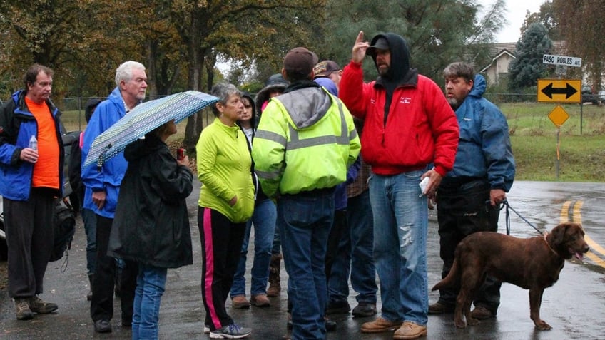 A group of people out in the rain searching for Sherri Papini