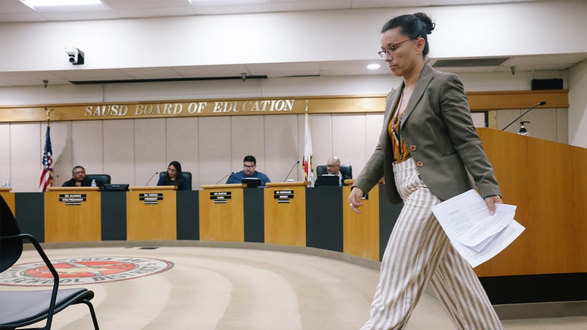 Robin Gurien walks back to her seat after speaking during a board meeting at the Santa Ana Unified School District Board Room on Tuesday, June 13, 2023 in Santa Ana, CA.