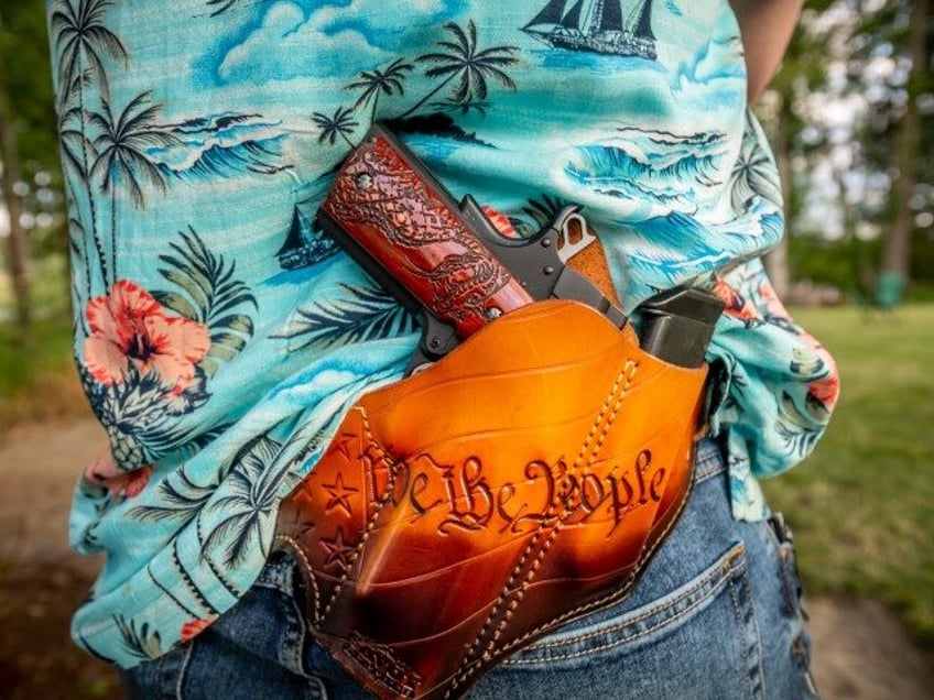 July 4th, 2020- Matt Marshall, a member of the Eatonville school board in Washington state, at a fund raiser and 4th of July BBQ in Eatonville. Here Marshall open carries a hand gun in a "We the People" holster. (Stuart Isett for The Washington Post via Getty)