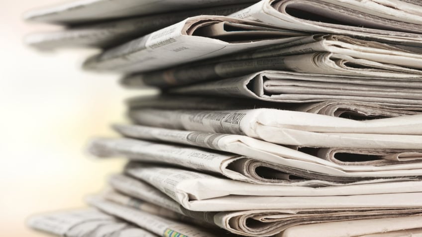 Pile of newspapers on white background