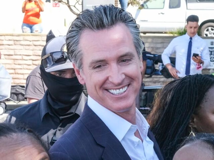 California Gov. Gavin Newsom takes photos with members of Bruce's family and Justice