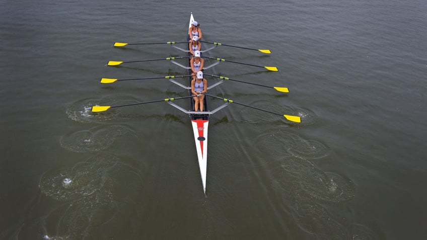 Members of the Vesper Rowing Club line up to compete in the 2012 National Rowing Championships at Cooper River in Cherry Hill, N.J., Saturday, July 14, 2012. (AP Photo/Camden Courier-Post, Jose F. Moreno) NO SALES; MANDATORY CREDIT