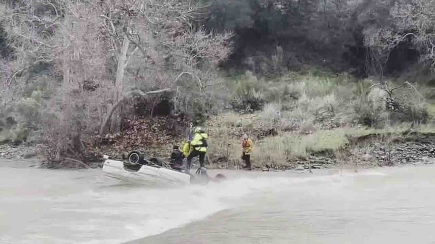 rescuer with woman on car