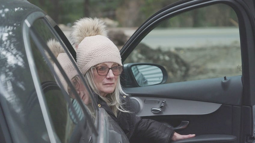 Judy Mordecai getting out of car at storage unit