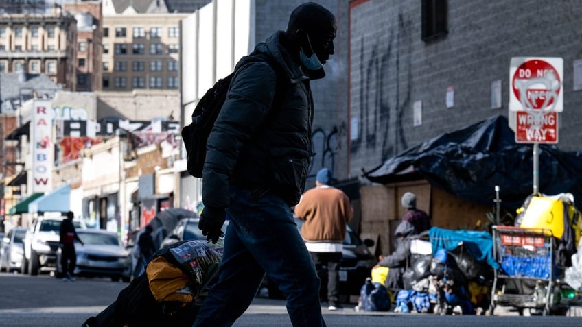 Los Angeles, CA - December 12:A homeless man walks through Los Angeles skid row on Monday, December 12, 2022. 