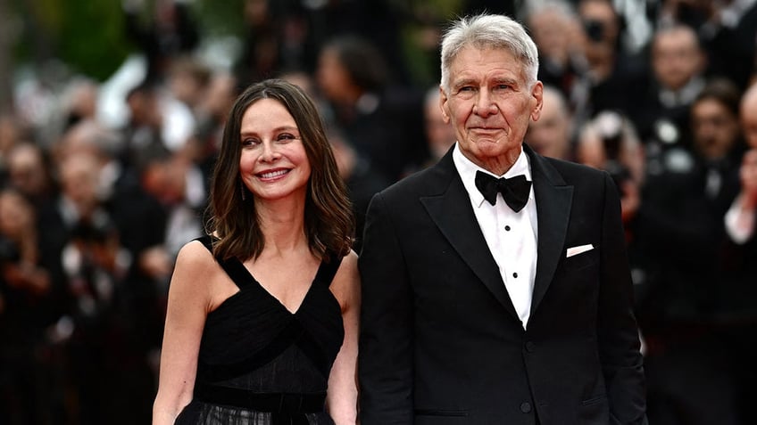 Calista Flockhart and Harrison Ford holding hands on the red carpet