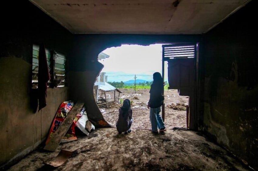 Indonesian rescuers race to find dozens of people still unaccounted for after flash floods