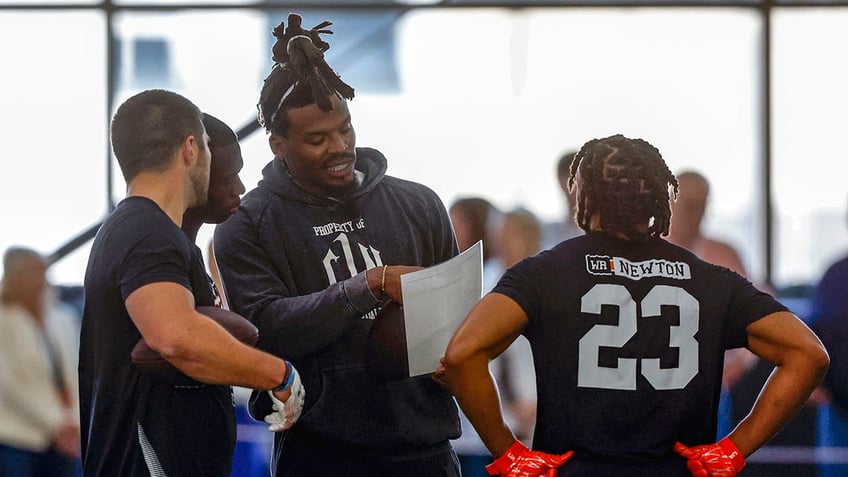 Cam Newton talks with wide receivers