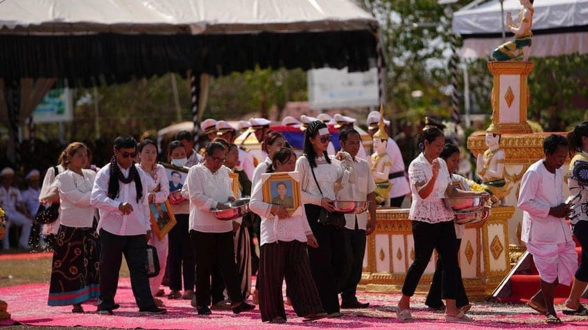 Cambodian soldiers' relatives gather for the funeral procession to all who died during an ammunition explosion in an army base in Kampong Speu province, Cambodia