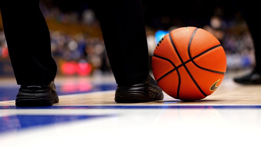 A referee and a basketball