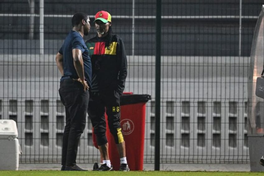 Cameroon football federation president Samuel Eto'o (L) talks to former coach Rigobert Son