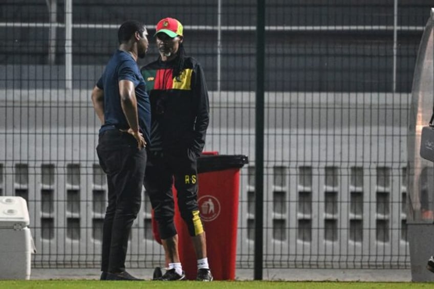 Cameroon football federation president Samuel Eto'o (L) talks to former coach Rigobert Son