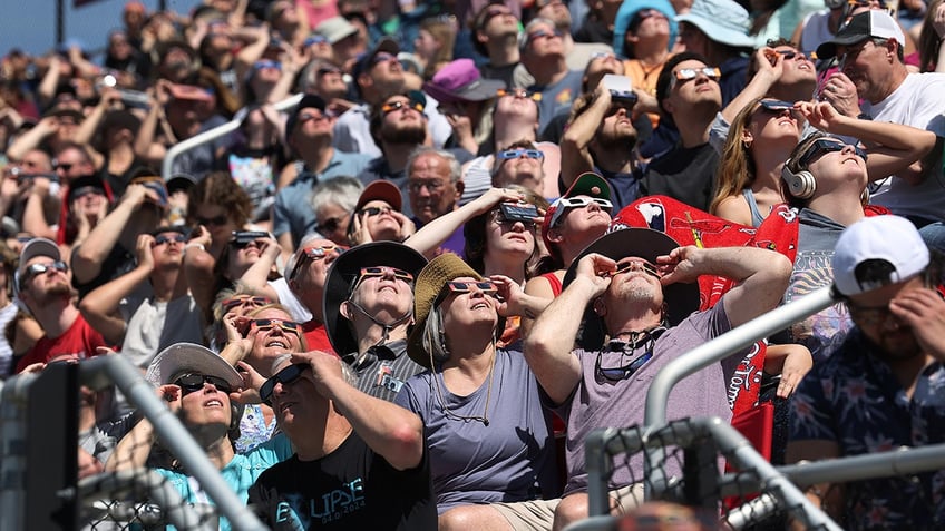 People view the start of the total eclipse on the campus of Southern Illinois University