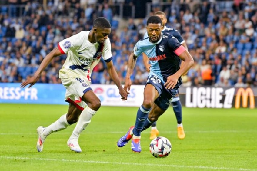 Ousmane Dembele (L) in action for Paris Saint-Germain against Le Havre on the opening nigh